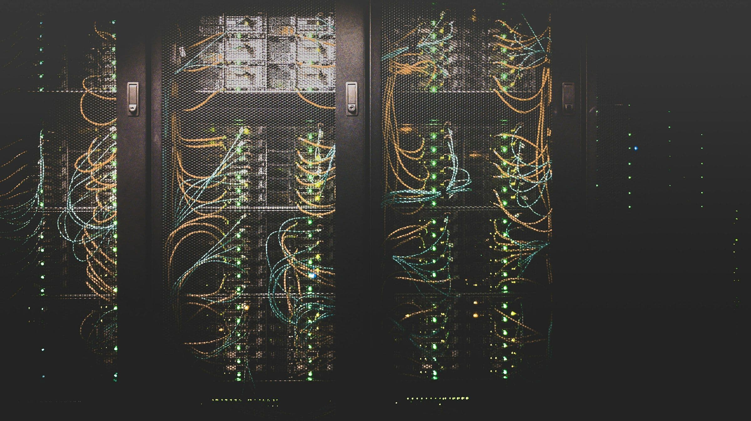 Server racks with network cables in a data centre, where a live website and its database run