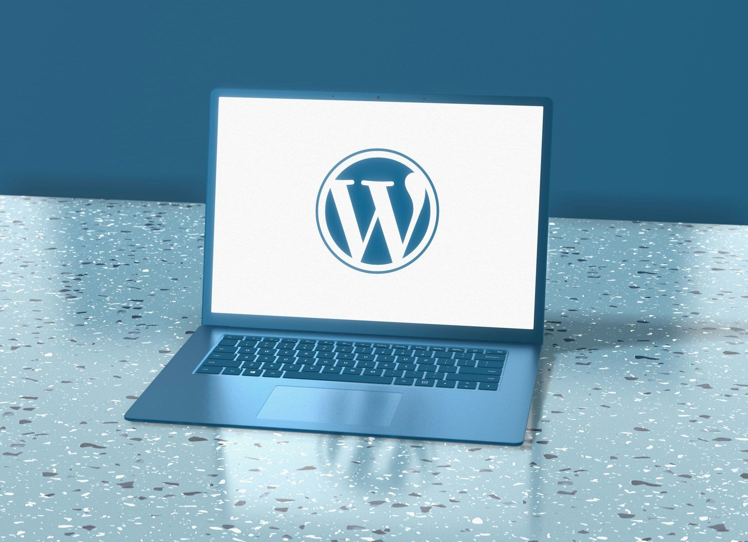 A laptop showing the WordPress logo, the platform many business websites are moving away from